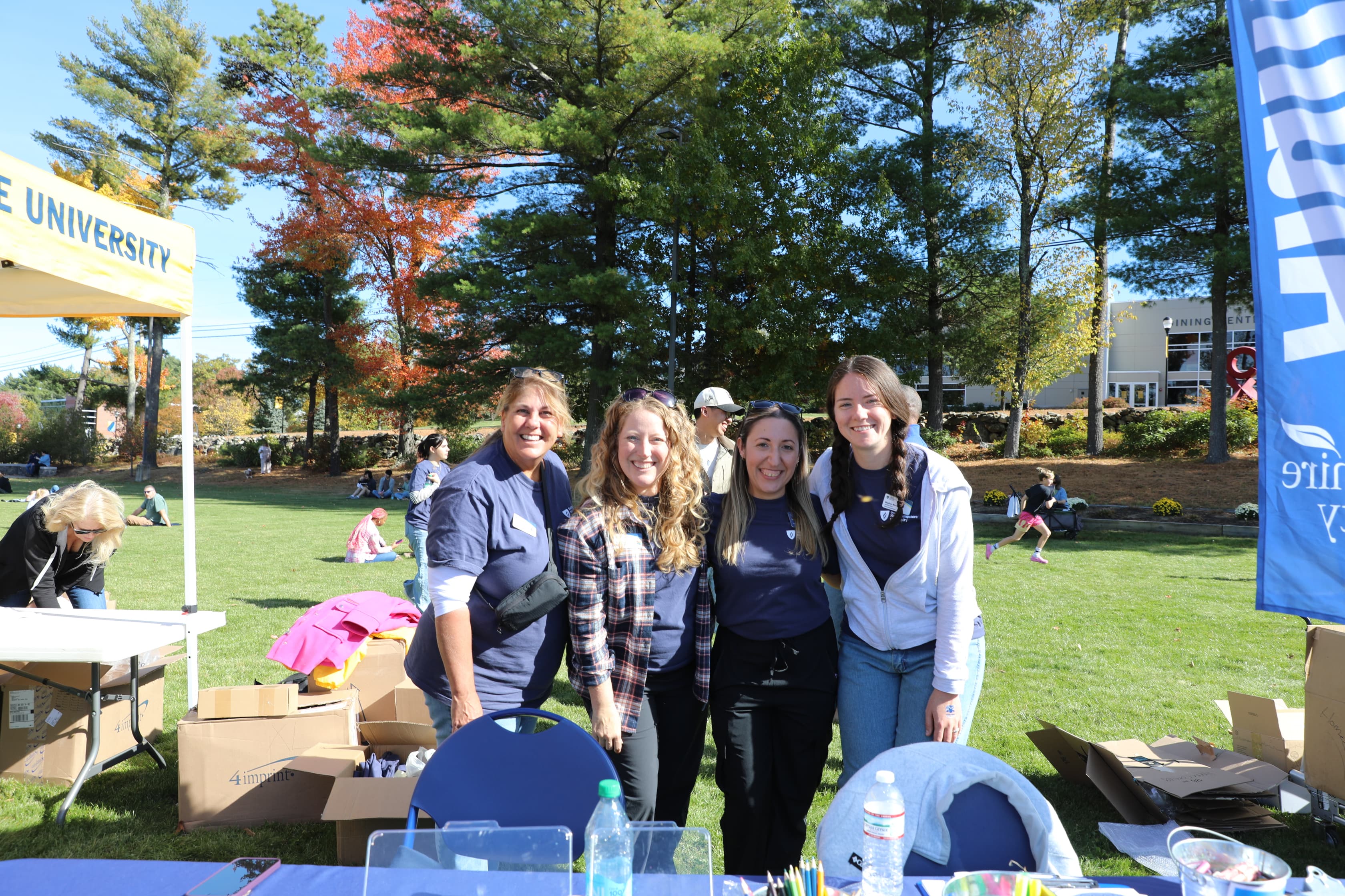Alumni volunteering at an outdoor campus event